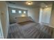 Upstairs loft space with carpeted floor, three windows, neutral paint and natural light at 84 Commons Cir, Clayton, NC 27520