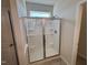 Modern bathroom shower featuring a sliding glass door and built-in shelving at 84 Commons Cir, Clayton, NC 27520