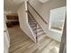 Bright foyer showcases a staircase with carpeted steps and black iron balusters at 84 Commons Cir, Clayton, NC 27520