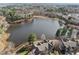 Scenic aerial shot of a tranquil lake surrounded by lush trees and elegant homes, showcasing community's natural beauty at 8410 Zinc Autumn Path, Raleigh, NC 27615