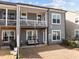 View of a townhouse backyard featuring a patio, balcony and small grassy area, perfect for outdoor living at 8410 Zinc Autumn Path, Raleigh, NC 27615