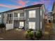 Back of the home featuring a second story screened-in porch and a walk-out patio at 8410 Zinc Autumn Path, Raleigh, NC 27615