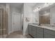Bright bathroom with double vanity, granite countertops, and a glass-enclosed shower at 8410 Zinc Autumn Path, Raleigh, NC 27615