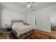 Comfortable bedroom with hardwood floors, ceiling fan, and a stylish platform bed with shelves at 8410 Zinc Autumn Path, Raleigh, NC 27615