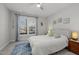 Sun-filled bedroom with a queen bed, large window, neutral walls, and light blue accents at 8410 Zinc Autumn Path, Raleigh, NC 27615