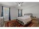 Cozy bedroom with a ceiling fan, a decorative rug and natural light from the windows at 8410 Zinc Autumn Path, Raleigh, NC 27615
