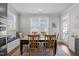 Bright dining space featuring a dining table with seating and a large window with a cushioned bench at 8410 Zinc Autumn Path, Raleigh, NC 27615
