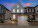 Charming two-story home featuring stone accents and an attached two-car garage with a long driveway at 8410 Zinc Autumn Path, Raleigh, NC 27615