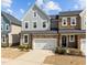 Charming two-story townhome with a stone and siding facade, complemented by a well-manicured front yard at 8410 Zinc Autumn Path, Raleigh, NC 27615