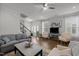 Bright living room with hardwood floors, comfortable seating, and staircase views with lots of natural light at 8410 Zinc Autumn Path, Raleigh, NC 27615