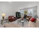 Open living area with neutral carpet, plush seating, workstation, and modern decor bathed in natural light at 8410 Zinc Autumn Path, Raleigh, NC 27615