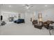 Expansive living area with neutral carpet, a ceiling fan, home office, and armchairs at 8410 Zinc Autumn Path, Raleigh, NC 27615