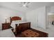 Spacious main bedroom features a wooden bed frame, dark wood nightstand, and a rug with an intricate design at 8410 Zinc Autumn Path, Raleigh, NC 27615