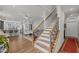 Elegant staircase showcasing hardwood steps, decorative iron spindles, and open-concept living area at 8410 Zinc Autumn Path, Raleigh, NC 27615
