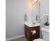 Well-lit bathroom with modern fixtures, a decorative flower, and a neutral color scheme at 8417 Henderson Rd, Apex, NC 27539