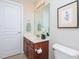 Bright bathroom with a decorative print, a white door, and a large mirror at 8417 Henderson Rd, Apex, NC 27539