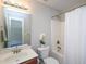 Bright bathroom with a large mirror, shower-tub, and view into an adjacent carpeted room at 8417 Henderson Rd, Apex, NC 27539