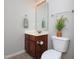 Bathroom with cherry cabinet vanity, neutral walls and flooring, and towel rack at 8417 Henderson Rd, Apex, NC 27539