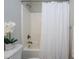 Clean bathroom featuring a shower-tub, a shower curtain, and white walls at 8417 Henderson Rd, Apex, NC 27539