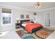 Comfortable bedroom with natural light, a ceiling fan, and a cozy rug at 8417 Henderson Rd, Apex, NC 27539