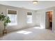 Spacious and bright bedroom featuring two large windows and neutral carpeting at 8417 Henderson Rd, Apex, NC 27539