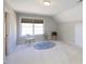 Bedroom featuring a large window, neutral carpet, and charming decor with rug and phonograph at 8417 Henderson Rd, Apex, NC 27539