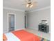 Bright bedroom with an open doorway, natural light, and colorful decor at 8417 Henderson Rd, Apex, NC 27539