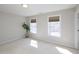 Bright bedroom featuring two large windows, neutral color walls, and carpeting at 8417 Henderson Rd, Apex, NC 27539