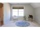 Bedroom featuring a large window, neutral carpet, and charming decor with rug and phonograph at 8417 Henderson Rd, Apex, NC 27539