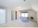 Bedroom featuring a large window, neutral carpet, and charming decor with rug and phonograph at 8417 Henderson Rd, Apex, NC 27539