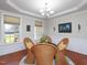 Elegant dining area featuring a stylish chandelier and plenty of natural light at 8417 Henderson Rd, Apex, NC 27539