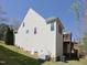 Exterior view of a home with an outdoor deck and basement entrance at 8417 Henderson Rd, Apex, NC 27539