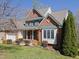 Attractive brick home with pristine lawn and mature landscaping at 8417 Henderson Rd, Apex, NC 27539