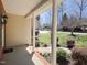 Covered front porch with brick accents and view of front lawn at 8417 Henderson Rd, Apex, NC 27539