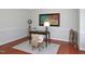 Bright home office features a wooden desk, neutral walls, and decor elements at 8417 Henderson Rd, Apex, NC 27539