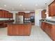 Spacious kitchen featuring an island, stainless steel appliances, and custom cabinetry at 8417 Henderson Rd, Apex, NC 27539