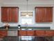 Well-lit kitchen with stainless steel appliances, undermount sink, wood cabinetry, and ample counter space at 8417 Henderson Rd, Apex, NC 27539