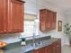 Bright kitchen featuring wood cabinetry, stainless steel appliances, and a large window overlooking the sink at 8417 Henderson Rd, Apex, NC 27539