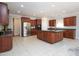 Spacious kitchen boasts a large island, stainless steel appliances, and tile flooring, creating a modern aesthetic at 8417 Henderson Rd, Apex, NC 27539