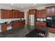 Open kitchen with a central island, stainless steel appliances, and wood cabinetry, ideal for Gathering gatherings at 8417 Henderson Rd, Apex, NC 27539