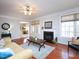Bright living room with hardwood floors, fireplace, and neutral décor, with lots of light at 8417 Henderson Rd, Apex, NC 27539