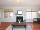 Bright living room with hardwood floors, fireplace, and neutral décor creating a cozy ambiance at 8417 Henderson Rd, Apex, NC 27539