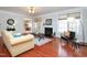 Comfortable living room with large windows, fireplace, and hardwood floors at 8417 Henderson Rd, Apex, NC 27539
