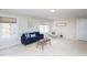 Spacious living room featuring a sofa and seating next to bright, natural light at 8417 Henderson Rd, Apex, NC 27539