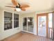Screened porch with wood flooring, screens, access door, and a ceiling fan at 8417 Henderson Rd, Apex, NC 27539