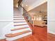 Open staircase with wood treads and black iron balusters, next to a living area at 8417 Henderson Rd, Apex, NC 27539