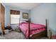 A blue-walled bedroom includes a window for natural light, carpeted floor, and a wooden bed frame at 900 Cricket Knoll Rd, Fuquay Varina, NC 27526