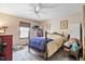 This bedroom features a ceiling fan, carpeted floors, and a comfortable bed at 900 Cricket Knoll Rd, Fuquay Varina, NC 27526