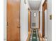 Hallway features wood doors, a decorative mirror, and a patterned runner at 900 Cricket Knoll Rd, Fuquay Varina, NC 27526