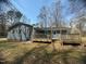 Rear view of the home featuring a large deck, a shed and a spacious yard at , Durham, NC 27712